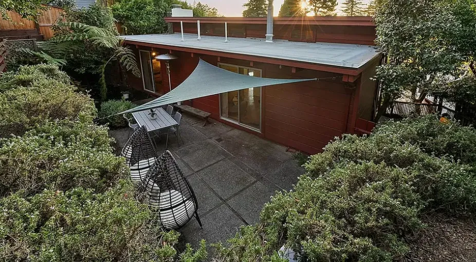 The back patio seen from above, wrapped in green