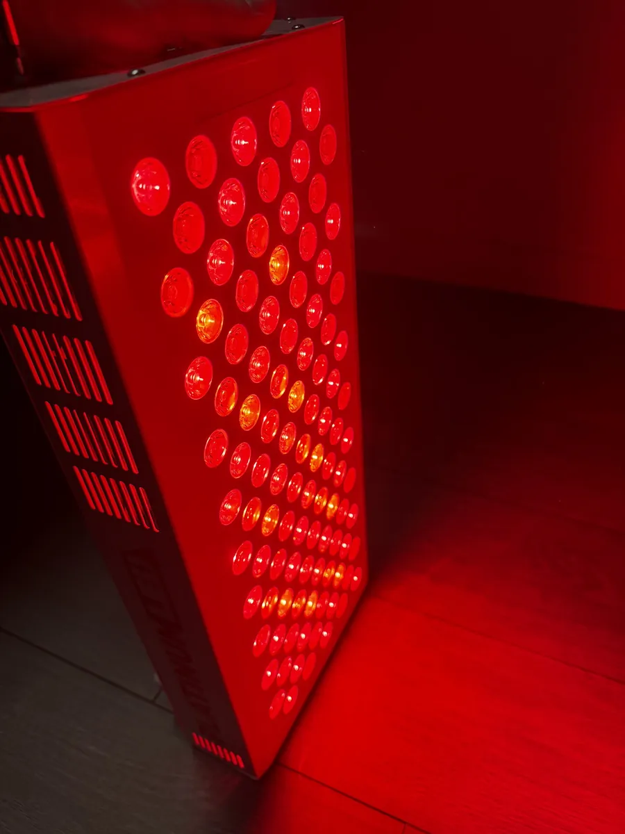 A red light panel glowing in a dark room