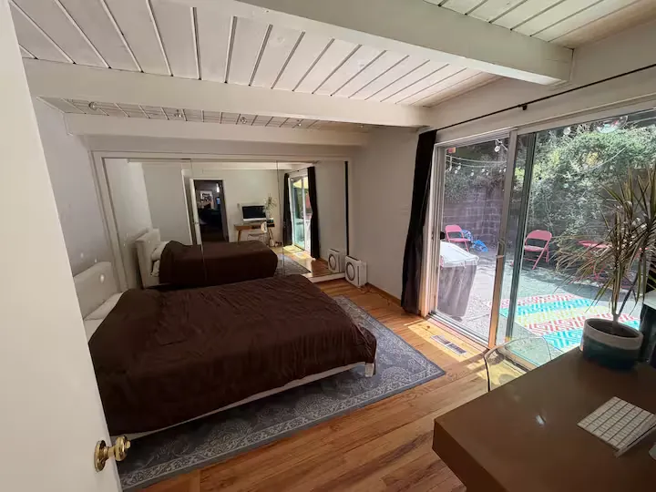 The bedroom today, with a glass slider that opens onto the patio