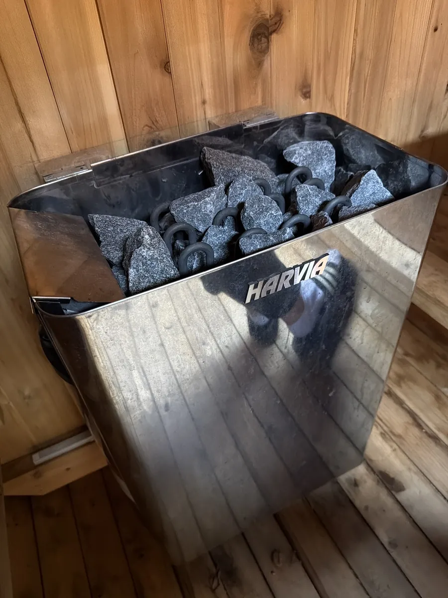 The Harvia heater and stones inside the cedar sauna